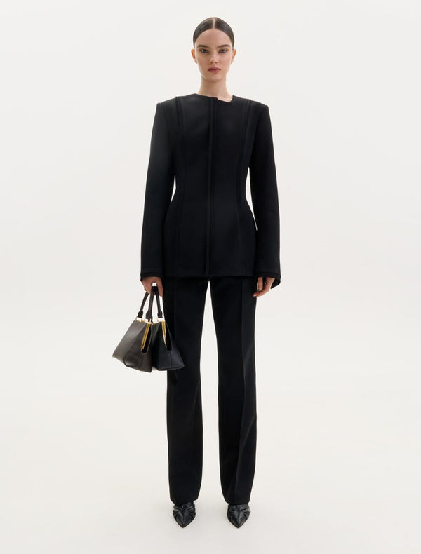 Black wool top with an asymmetric neckline