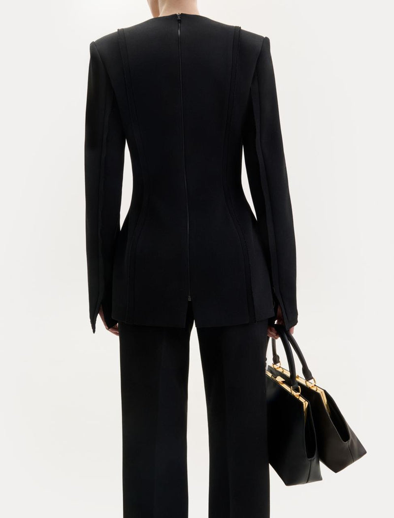 Black wool top with an asymmetric neckline